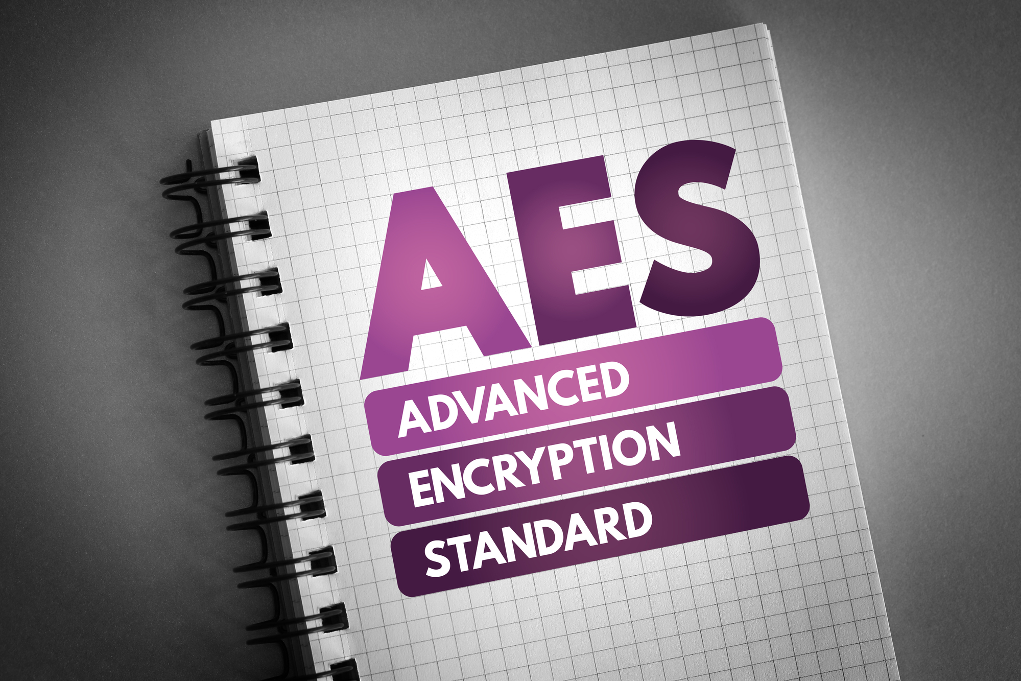 A notebook with the words "AES-256 Encryption Advanced Encryption Standard" on it.